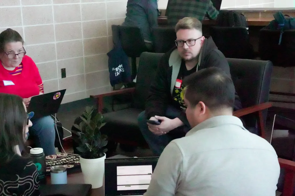 Attendees chatting in a small group with laptops at Desert Dev Lab 2026